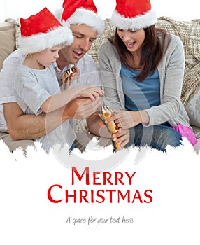 Composite image of happy parents with thir opening crackers together