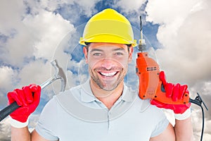 Composite image of happy repairman holding hammer and drill machine
