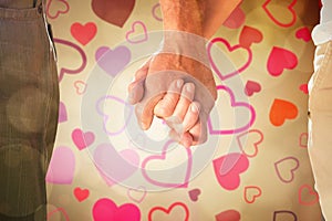 Composite image of happy senior couple holding hands