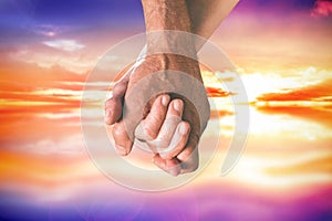 Composite image of happy senior couple holding hands