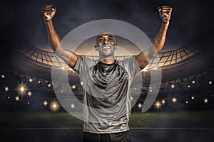 Composite image of happy sportsman with clenched fist after victory