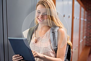 Composite image of happy student using tablet