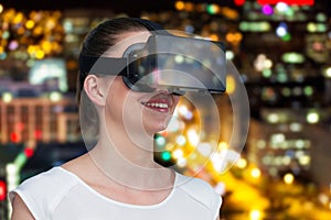 Composite image of happy woman experiencing virtual reality headset