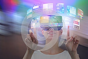 Composite image of happy woman pointing upwards while using virtual reality headset