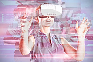 Composite image of happy young businesswoman gesturing while wearing virtual reality glasses