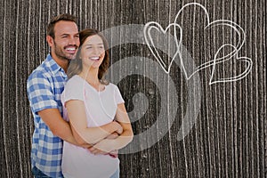 Composite image of happy young couple embracing