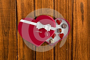 Composite image of heart shaped box of candy