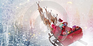 Composite image of high angle view of santa claus riding on sled with gift box