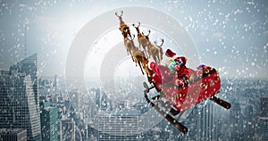 Composite image of high angle view of santa claus riding on sled with gift box