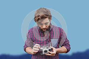 Composite image of hipster using camera