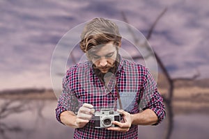 Composite image of hipster using camera