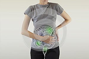 Composite image of infected intestine highlighted green on woman`s body