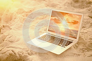 Composite image of laptop kept on sand at beach