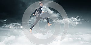 Composite image of leaping businessman