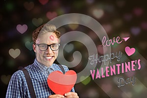 Composite image of love message and nerd man holding red heart