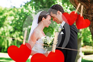 Composite image of loving newly wed couple in garden