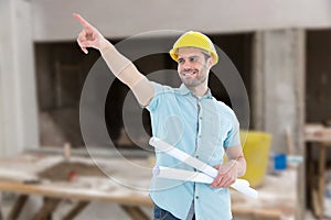 Composite image of male architect with blueprints pointing away