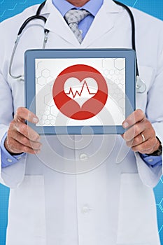Composite image of male doctor showing digital tablet on white background
