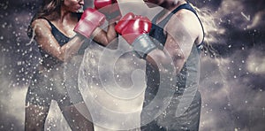 Composite image of male and female boxer with fighting stance