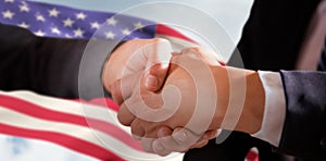 Composite image of male and female corporates shaking hands photo