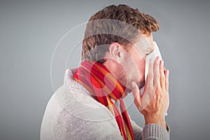 Composite image of man blowing nose on tissue