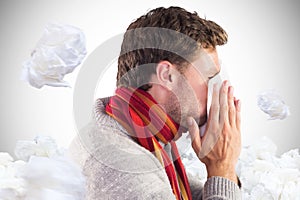 Composite image of man blowing nose on tissue