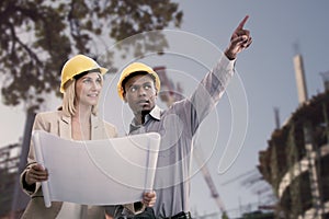 Composite image of man gesturing while standing with female architect