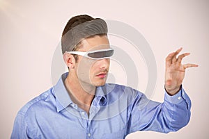 Composite image of man gesturing while using virtual video glasses