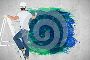 Composite image of man on ladder painting with roller