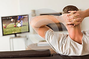 Composite image of man relaxing on his couch