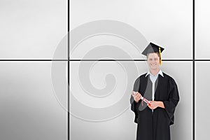 Composite image of man smiling as he has just graduated with his degree