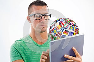 Composite image of man wearing glasses while using tablet computer