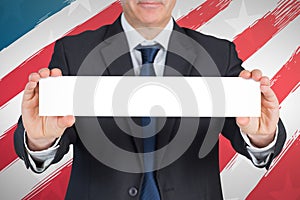 Composite image of mature businessman showing card