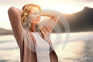 Composite image of mature woman stretching with eyes closed