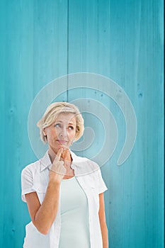 Composite image of mature woman thinking with hand on chin