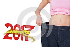 Composite image of mid section of beautiful females body in old jeans