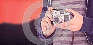 Composite image of mid section of man with camera