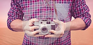 Composite image of mid section of man using camera