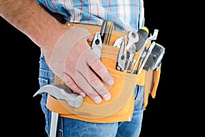 Composite image of midsection of handyman wearing tool belt