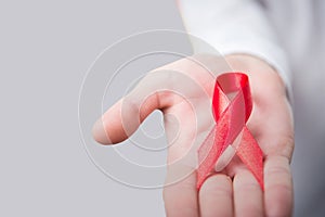 Composite image of midsection of person holding aids awareness ribbon