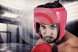 Composite image of muscular man boxing in gloves