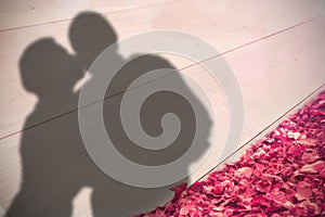 Composite image of older affectionate couple holding red heart shape