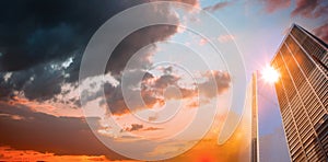 Composite image of orange and blue sky with clouds