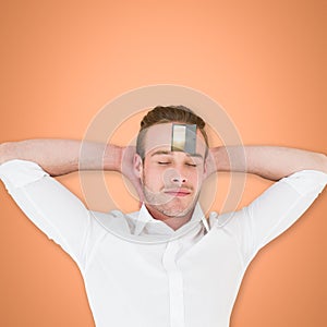 Composite image of overhead view of sleeping man with hands behind head