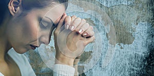 Composite image of peaceful woman praying with joining hands and eyes closed