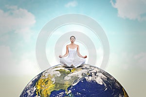 Composite image of peaceful woman in white sitting in lotus pose