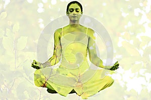 Composite image of peaceful woman in white sitting in lotus pose