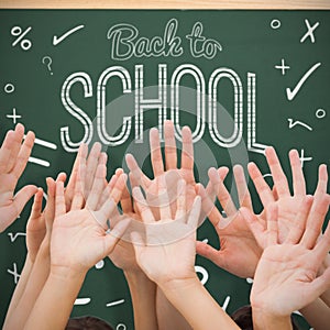 Composite image of people raising hands in the air