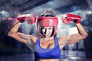 Composite image of portrait of angry female boxer flexing muscles