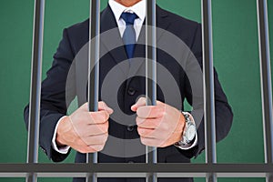 Composite image of portrait of a businessman clenching fists